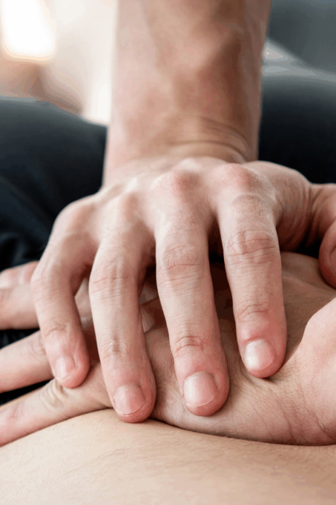 Physical therapist helping a patient recover from winter back pain.