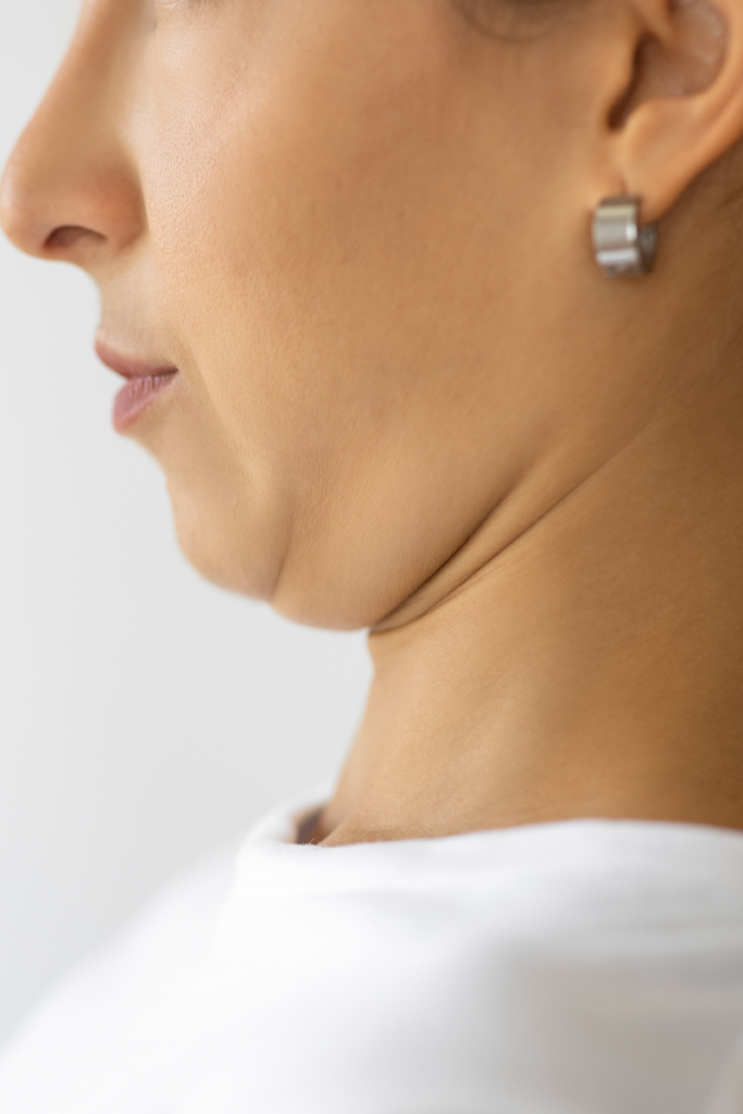 Person doing neck and shoulder stretches with a chin tuck at their desk