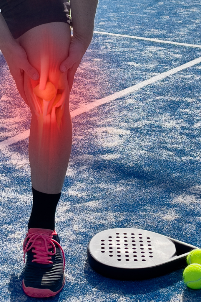 Pickleball player holding elbow and knee due to common pickleball-related injuries.