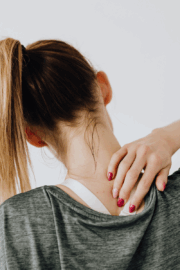 Adult experiencing jaw pain and neck tension.