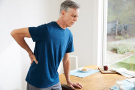 Elderly-man-holding-lower-back-in-pain reform physical therapy