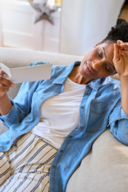 Middle-aged woman experiencing pelvic pressure while standing in her kitchen during menopause