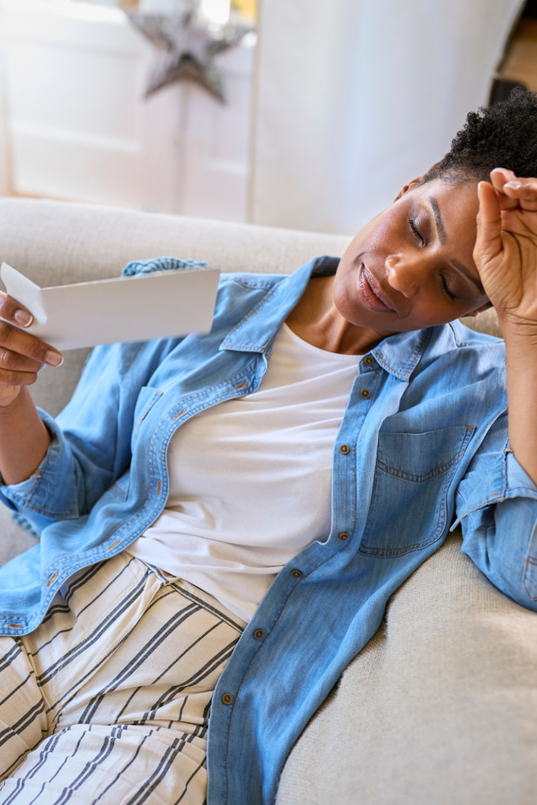 Middle-aged woman experiencing pelvic pressure while standing in her kitchen during menopause