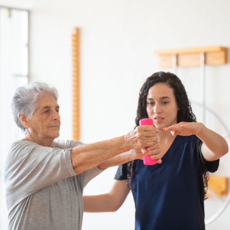 Physical therapist evaluating patient movement during a personalized physical therapy assessment.