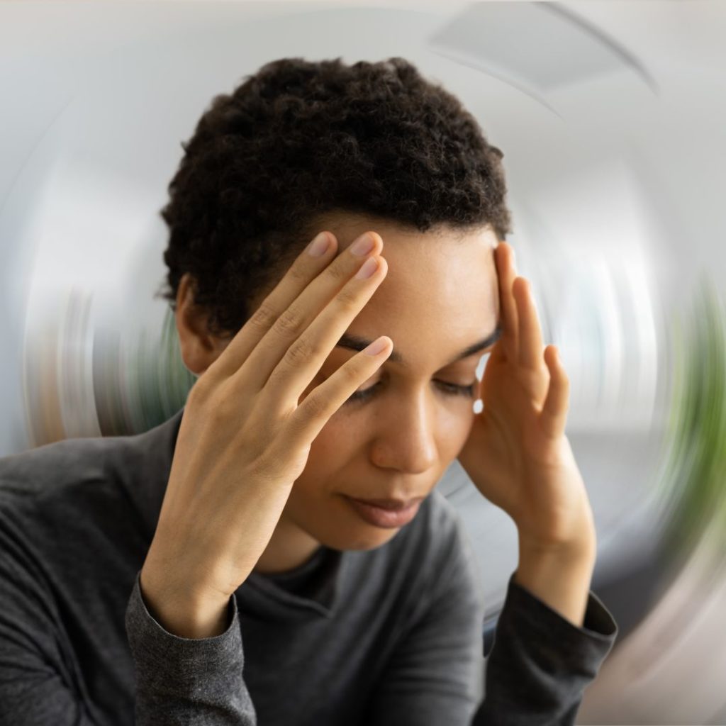 Woman experiencing dizziness signs that may require medical help