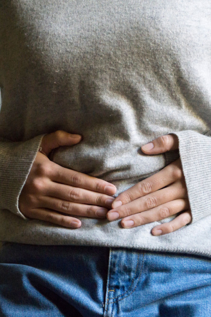 Woman stretching to relieve pelvic floor physical therapy for menopause discomfort and pelvic pressure